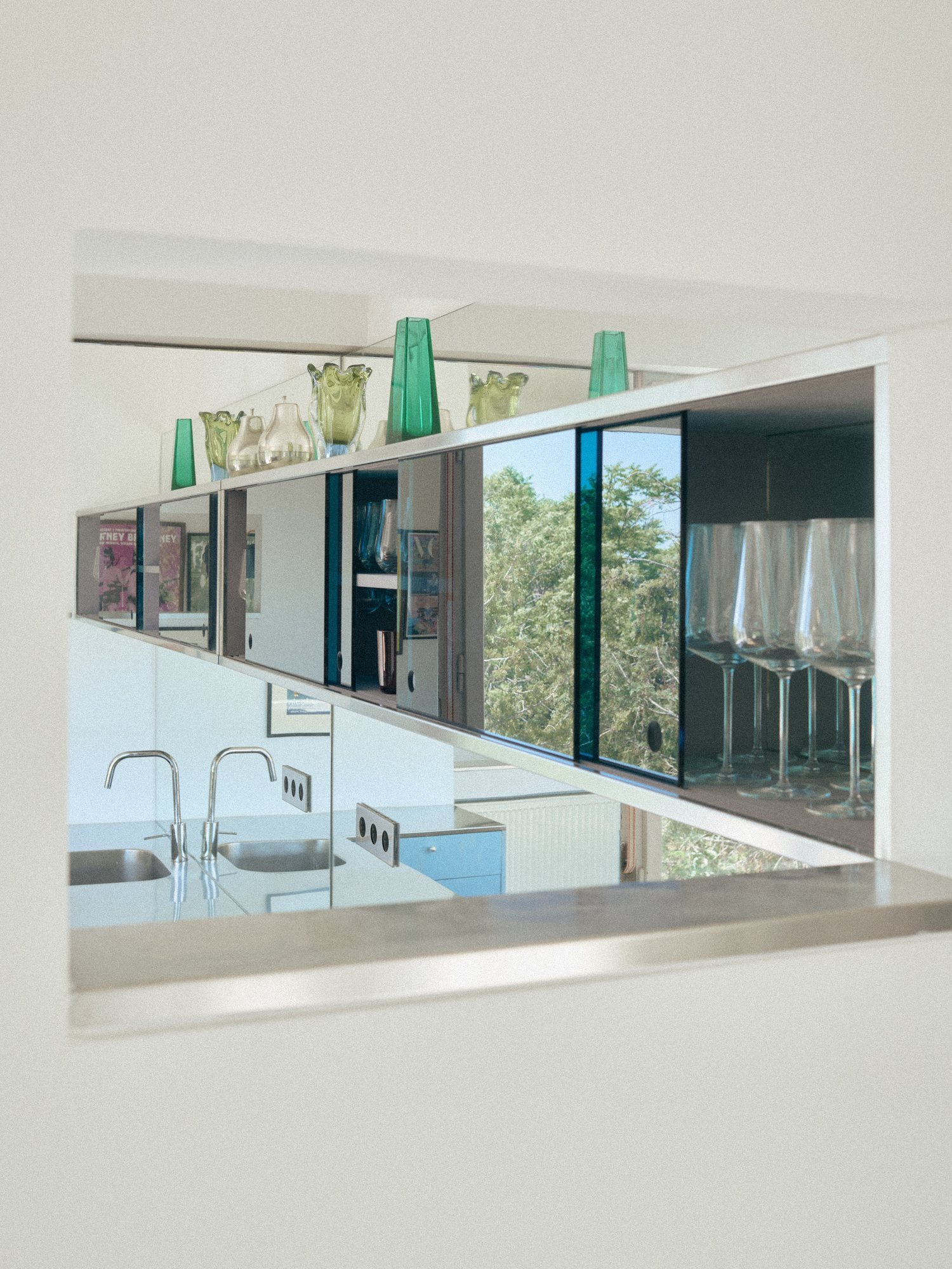 Interior window with a glassware collection in the B75 kitchen