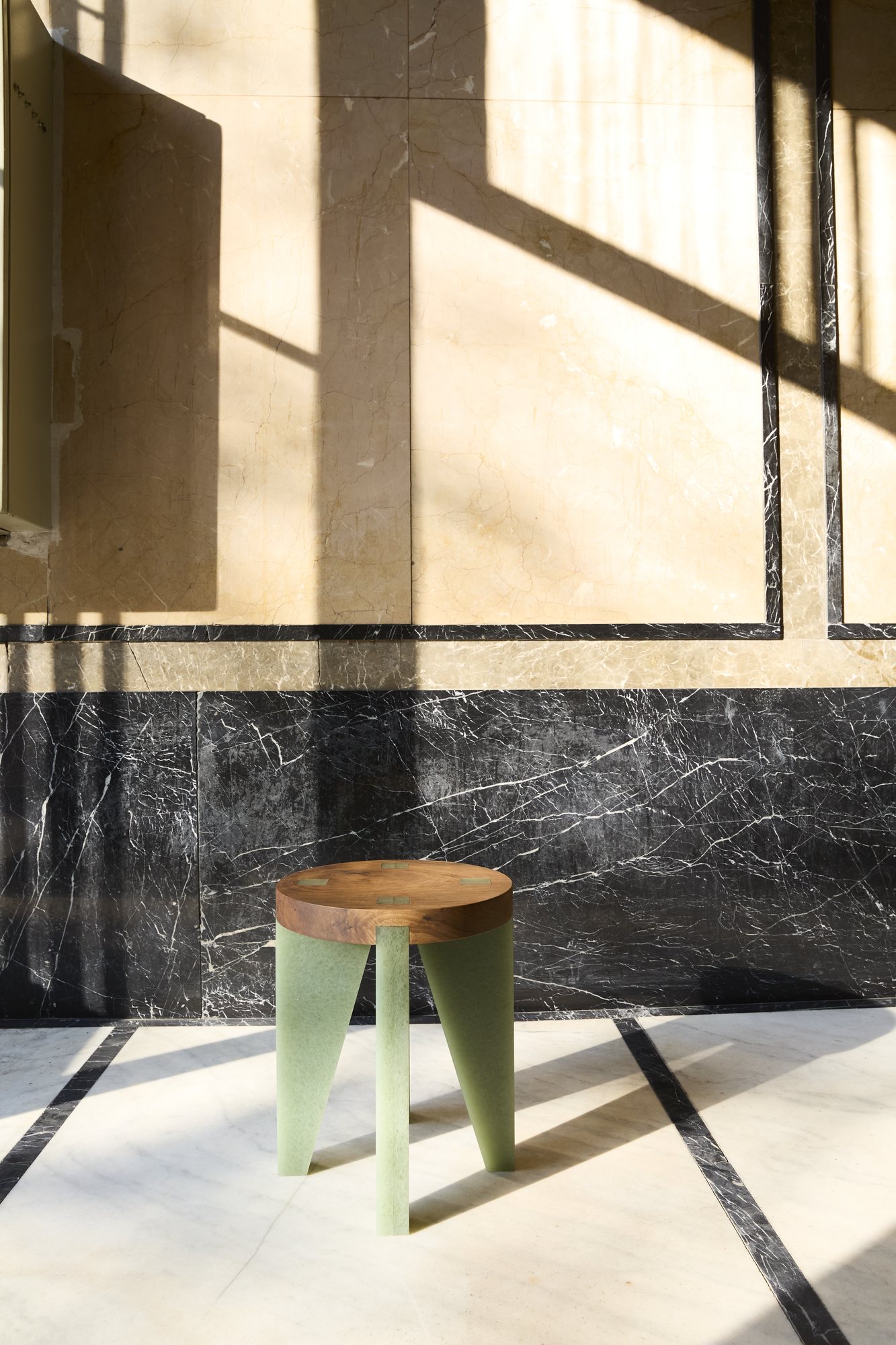 NANO Stool in walnut and green Karlite on a marble floor in the sun